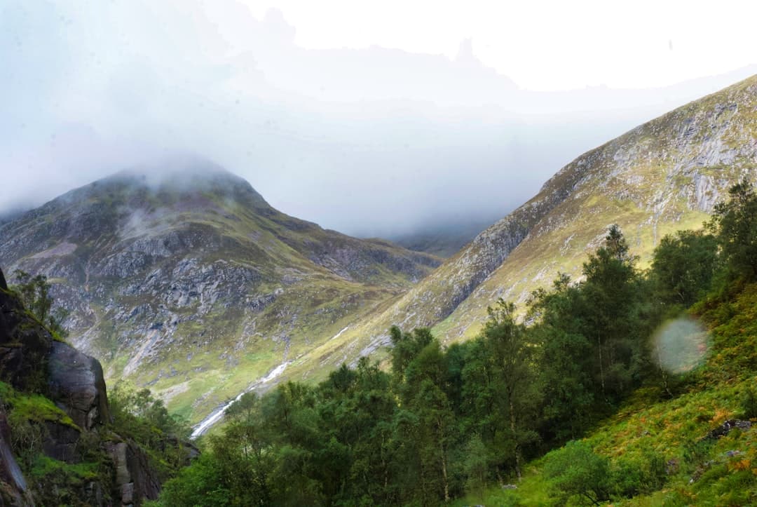 Fell runners competing on steep mountainous terrain in the UK countryside