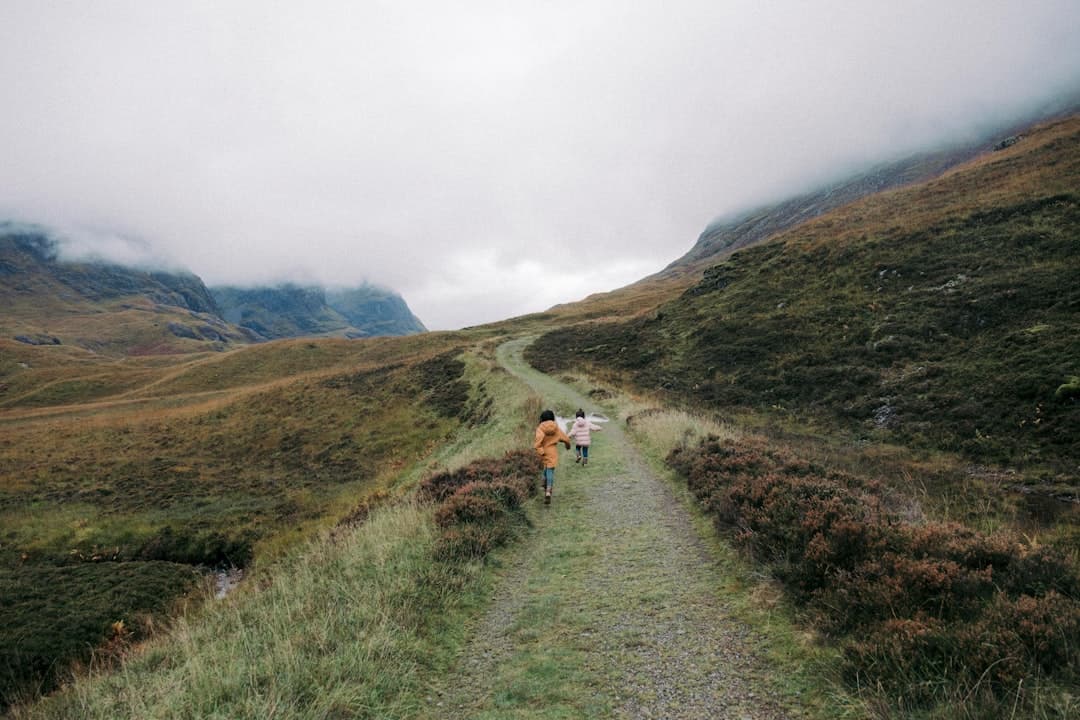 Trail runner sprinting down a rocky mountain path in the UK Lake District
