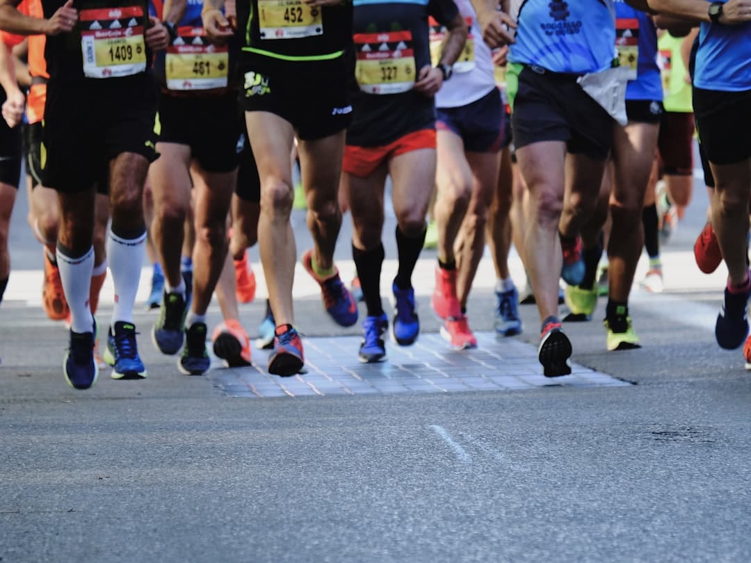 A group of beginner runners at the starting line of a 10k race, ready to begin their run